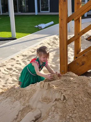 Child building sandcastle at our facility
